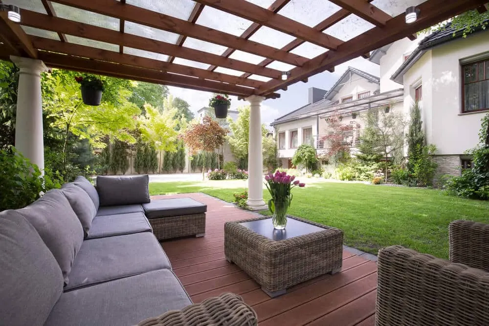 Covered pergola over a deck with outdoor sofas and a coffee table